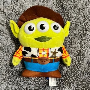 Disney alien character from toy story but dressed in a woody outfit.